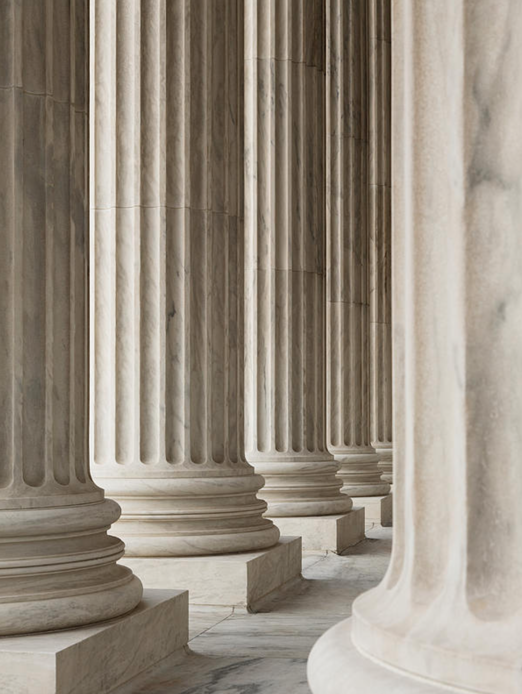 Close view of fluted marble columns and bases