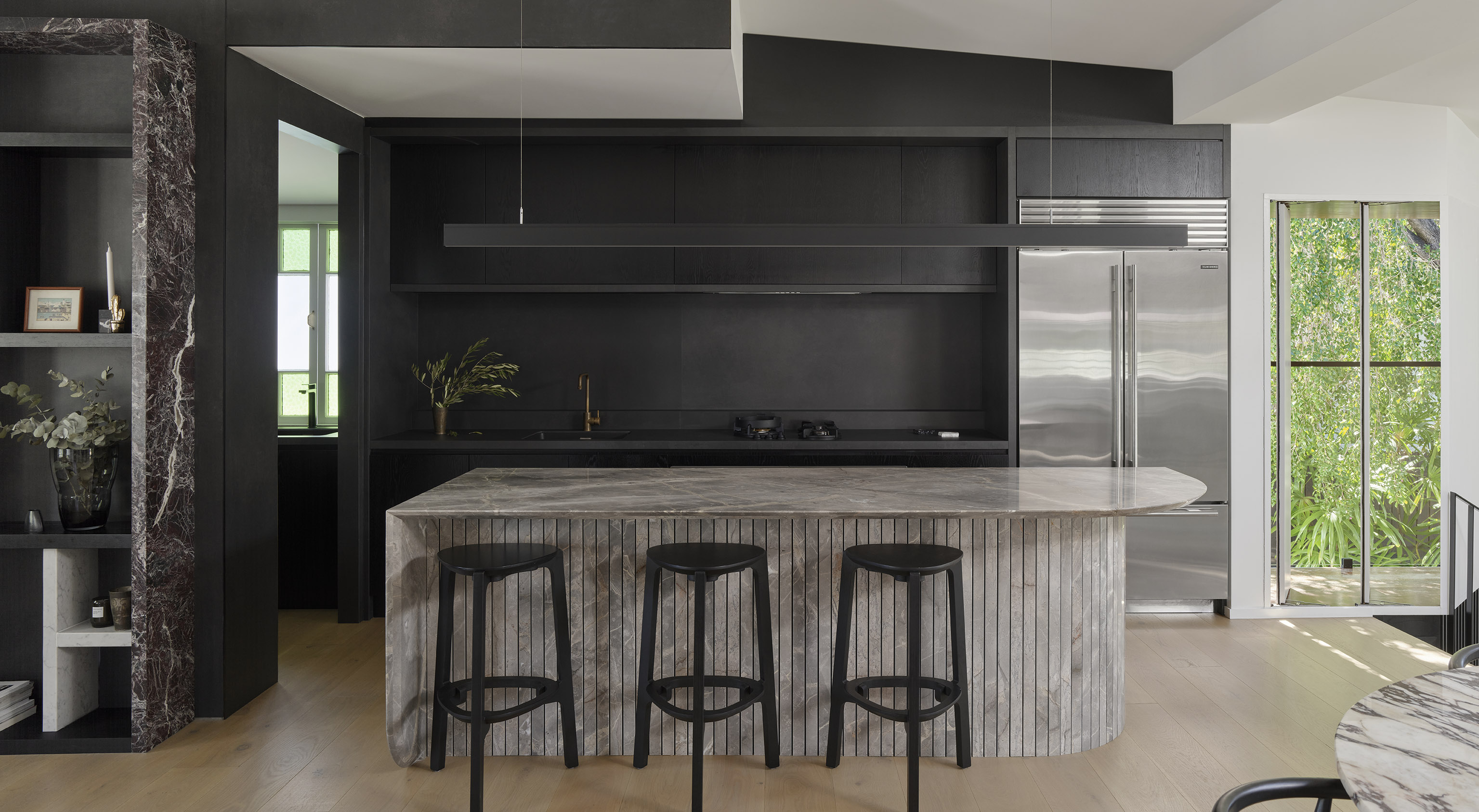 Dark kitchen with grey natural stone island