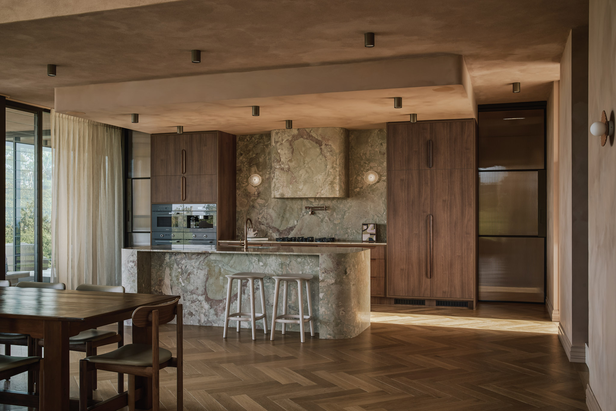 Warm wood kitchen with dramatic natural stone island