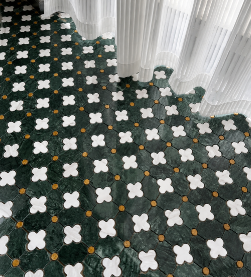 Green and white flower-pattern stone mosaic floor beside sheer curtains