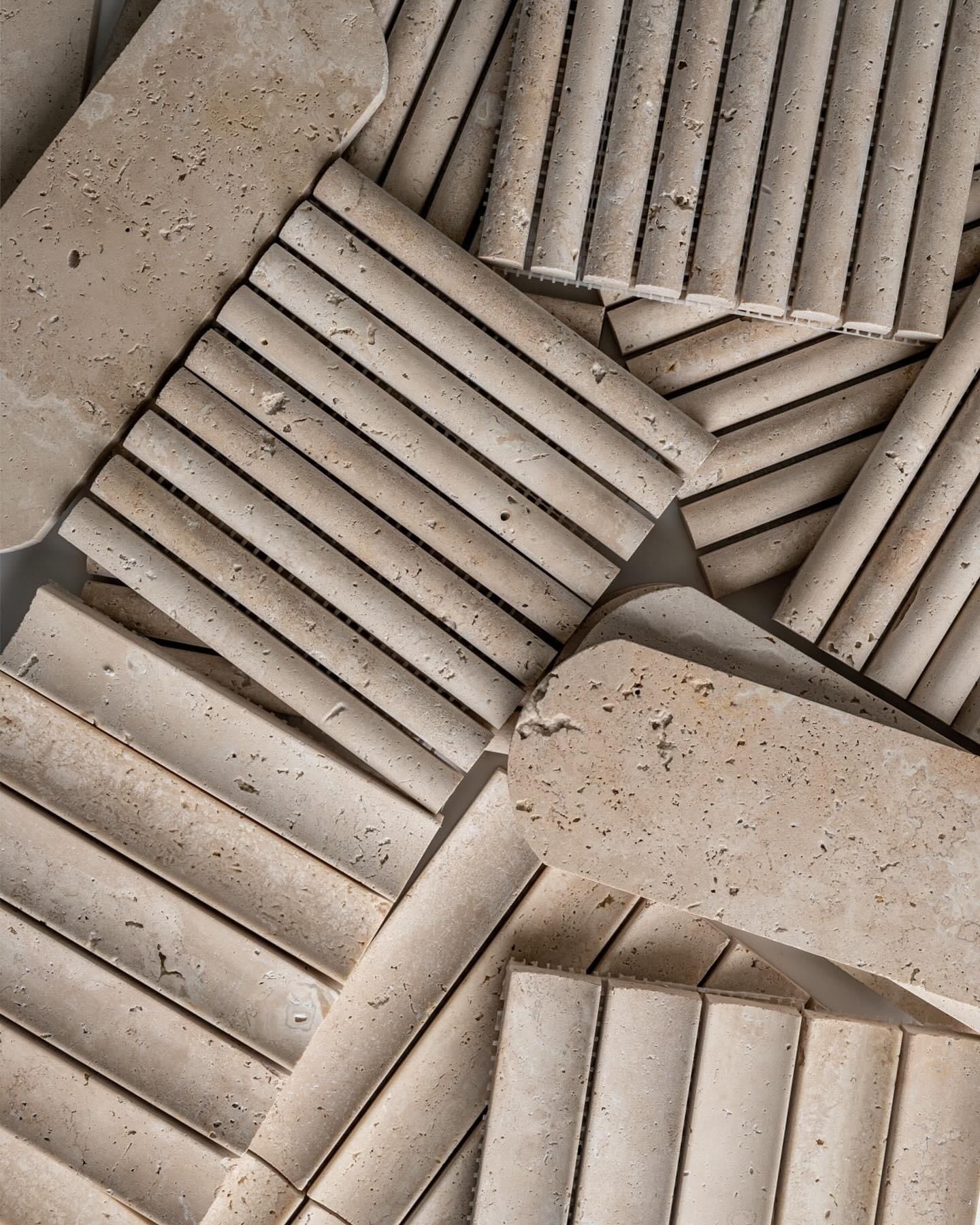 Beige linear travertine mosaic pieces and curved stone samples