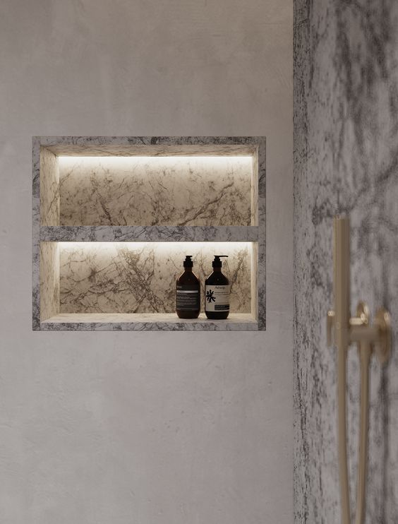Illuminated stone niche integrated into a bathroom wall
