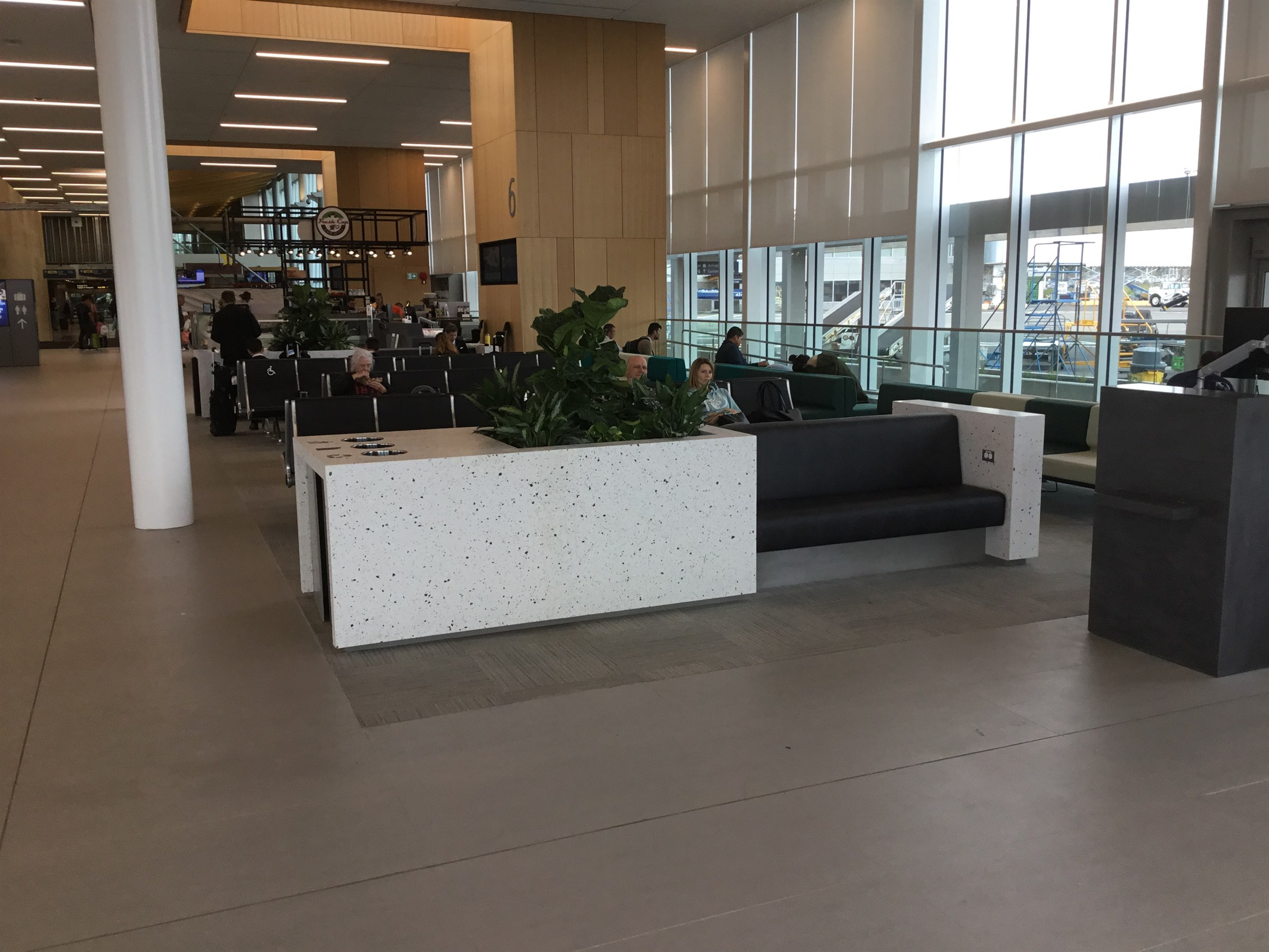 White terrazzo planter integrated with airport seating