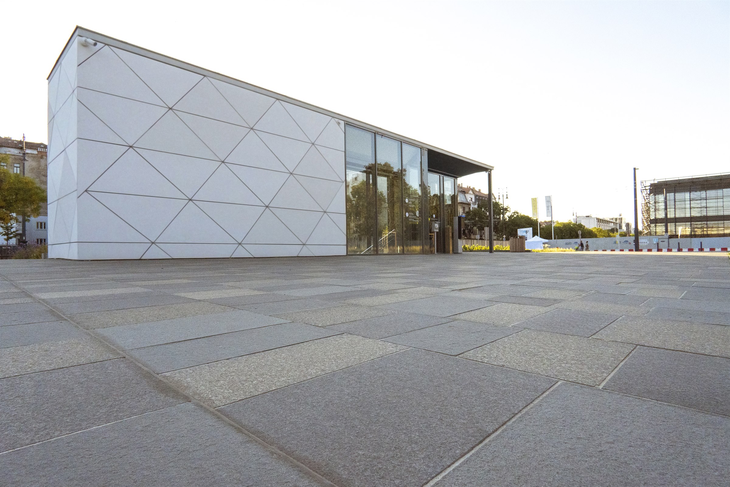 Granite plaza in front of a modern public pavilion