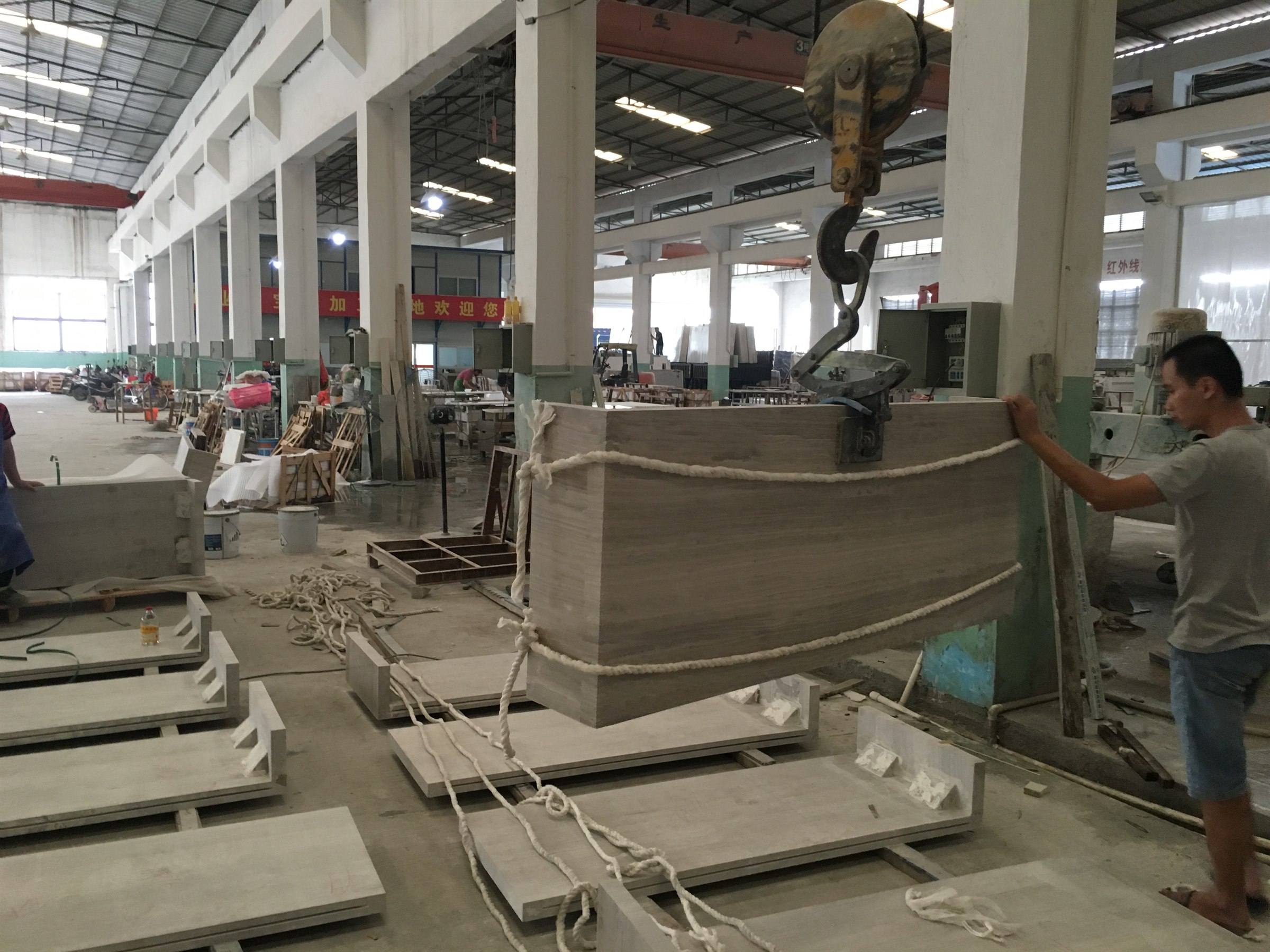Large custom marble component being handled in the workshop