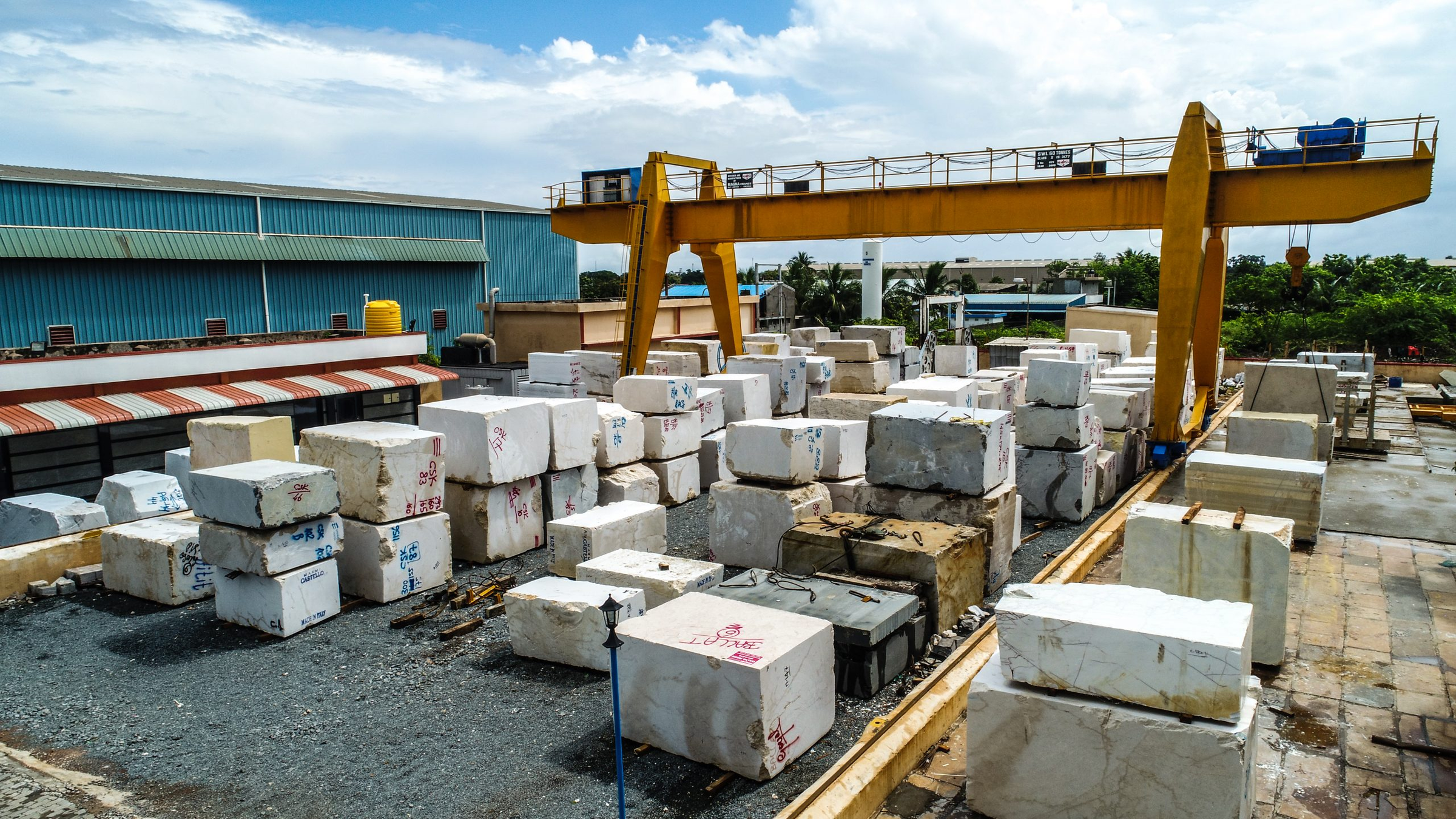 Stone block yard with crane and marble blocks