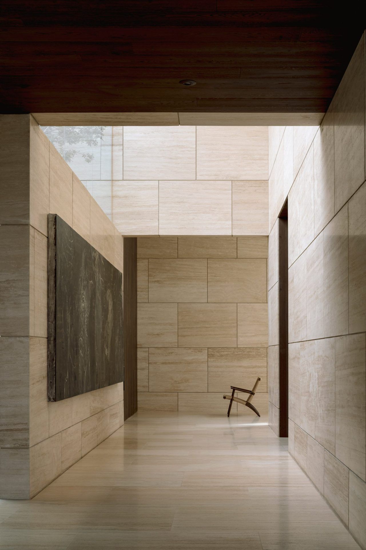 Pale stone-clad architectural corridor